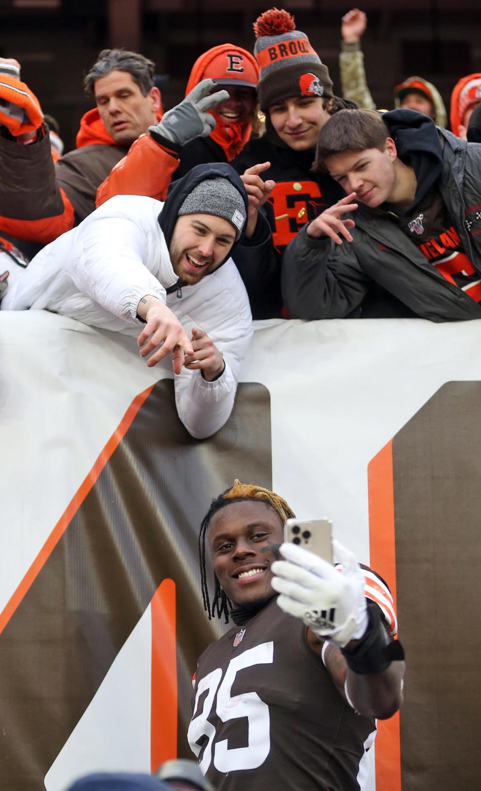 Cleveland Browns tight end David Njoku (85) takes a selfie with fans after an NFL football game against the Cincinnati Bengals, Sunday, Jan. 9, 2022, in Cleveland, Ohio.