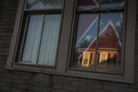 A confederate flag hangs in the window of a home of a young Black woman in Shawnee Ohio, on Tuesday, July 28, 2020. Confederate flags have become a symbol of a certain America: white, often rural, sometimes southern, normally conservative. This time, though, it turned out to be a young Black woman who was flying it. She said it was her way of "giving the finger" to everyone, including white Southerners who believe they control the flag and its symbolism. (AP Photo/Wong Maye-E)