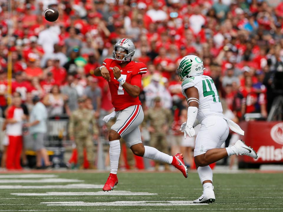 Ohio State Buckeyes quarterback C.J. Stroud (7) throws over Oregon Ducks linebacker Mase Funa (47) during the first half of the NCAA football game at Ohio Stadium in Columbus on Saturday, Sept. 11, 2021. 