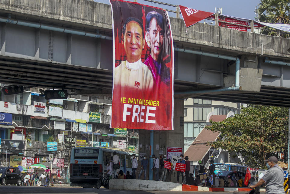 Pictures of detained Myanmar President Win Myint and leader Aung San Suu Kyi are displayed at an intersection against the military coup in Yangon, Myanmar Tuesday, Feb. 16, 2021. Security forces in Myanmar pointed guns toward anti-coup protesters and attacked them with sticks Monday, seeking to quell the large-scale demonstrations calling for the military junta that seized power this month to reinstate the elected government. (AP Photo)