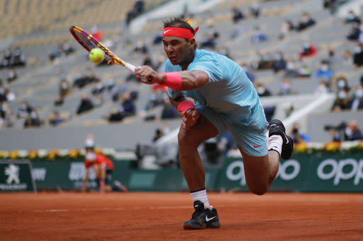 Spain's Rafael Nadal plays a shot against Mackenzie McDonald of the U.S. in the second round match of the French Open tennis tournament at the Roland Garros stadium in Paris, France, Wednesday, Sept. 30, 2020. (AP Photo/Christophe Ena)