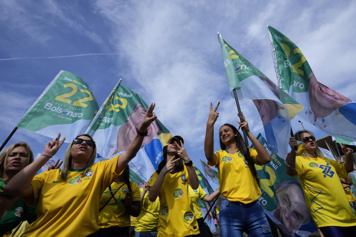 Supporters dance during a campaign event for incumbent President Jair Bolsonaro, in Brasilia, Brazil, Saturday, Oct. 29, 2022. Bolsonaro is facing former President Luiz Inacio Lula da Silva in a runoff election set for Oct. 30. (AP Photo/Eraldo Peres)