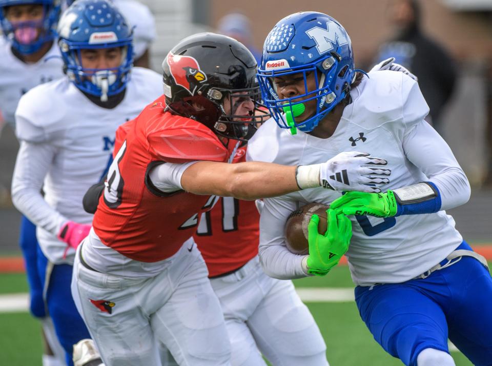 Metamora's Cameron Nickel, left, chases down Decatur MacArthur's Nahjir Woods in the first half of their Class 5A first-round state football playoff game Saturday, Oct. 28, 2023 in Metamora.