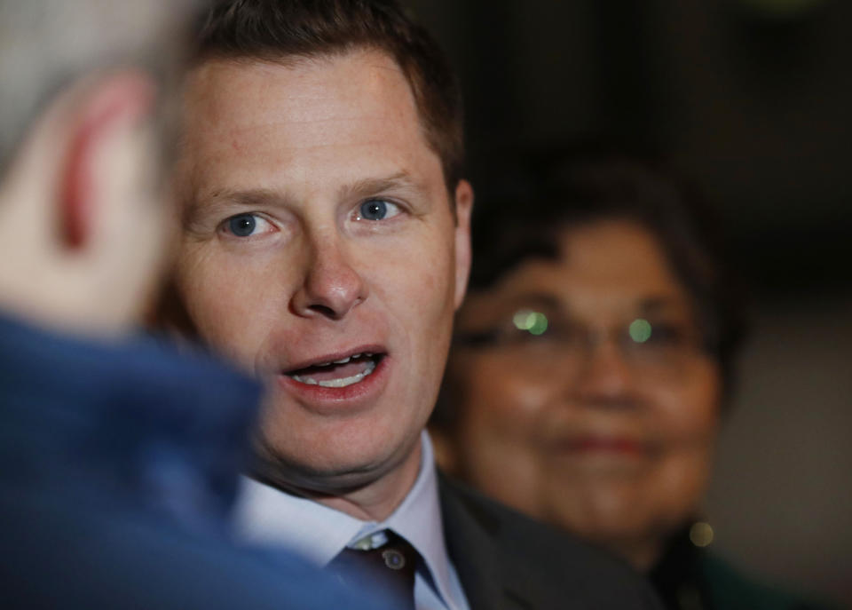 Attorney Jason Wesoky, front, responds to questions as Polly Baca, back, looks on after arguments in a lawsuit were heard Monday, Dec. 12, 2016, outside the federal courthouse in downtown Denver. Two Democratic electors are trying to be freed of Colorado's requirement that they vote for the winner of the state's popular vote in the presidential election this past November. (AP Photo/David Zalubowski)