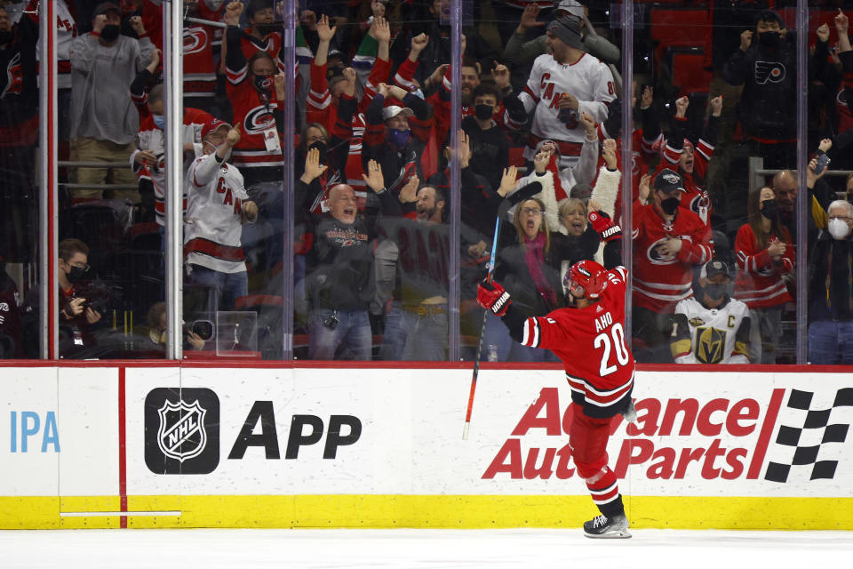 RALEIGH, NORTH CAROLINA - JANUARY 25: Sebastian Aho #20 of the NHL&#39;s Carolina Hurricanes celebrates scoring the game-winning goal during overtime of the game against the Vegas Golden Knights at PNC Arena on January 25, 2022 in Raleigh, North Carolina. (Photo by Jared C. Tilton/Getty Images)