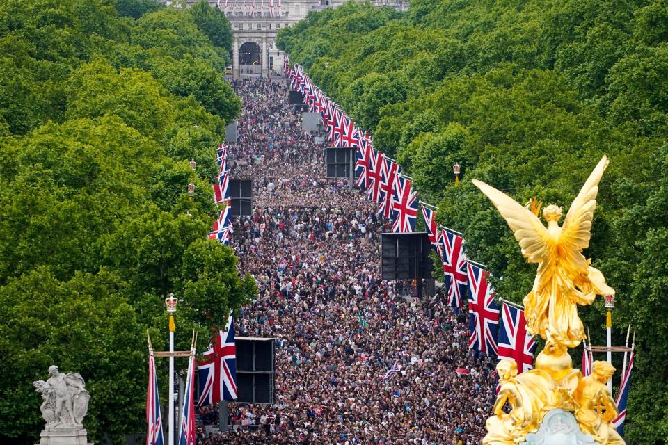 Crowds on the Mall watch the Platinum Jubilee concert, taking place in front of Buckingham Palace, London, Saturday June 4, 2022, on the third of four days of celebrations to mark the Platinum Jubilee. The events over a long holiday weekend in the U.K. are meant to celebrate Queen Elizabeth II's 70 years of service. (Niklas Halle'n/Pool Photo via AP)