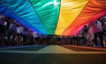 <p>Marchers unfurl a huge rainbow flag as they prepare to march in the Equality March for Unity and Pride in Washington, Sunday, June 11, 2017. (Photo: Carolyn Kaster/AP) </p>
