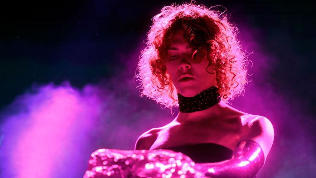 Sophie performs at the 2019 Coachella Music Festival wearing a black choker and pink gloves