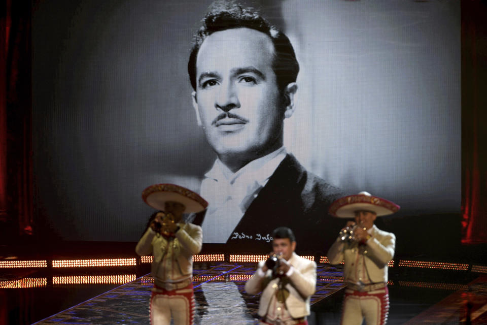 Mariachi Sol de Mexico de Jose Hernandez performs with Mexican-American singer and songwriter Lupita Infante for the 21st Latin Grammy Awards, airing on Thursday, Nov. 19, 2020, at American Airlines Arena in Miami. Their performance celebrates Infante's grandfather, Pedro Infante seen in the background screen.(AP Photo/Taimy Alvarez)