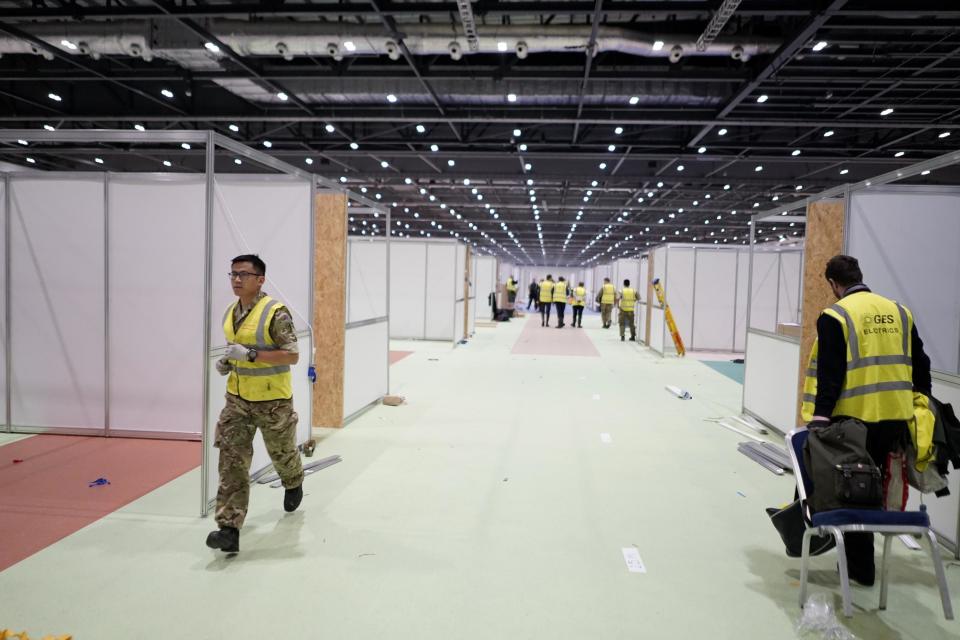 Workers building London's NHS Nightingale hospital (PA)