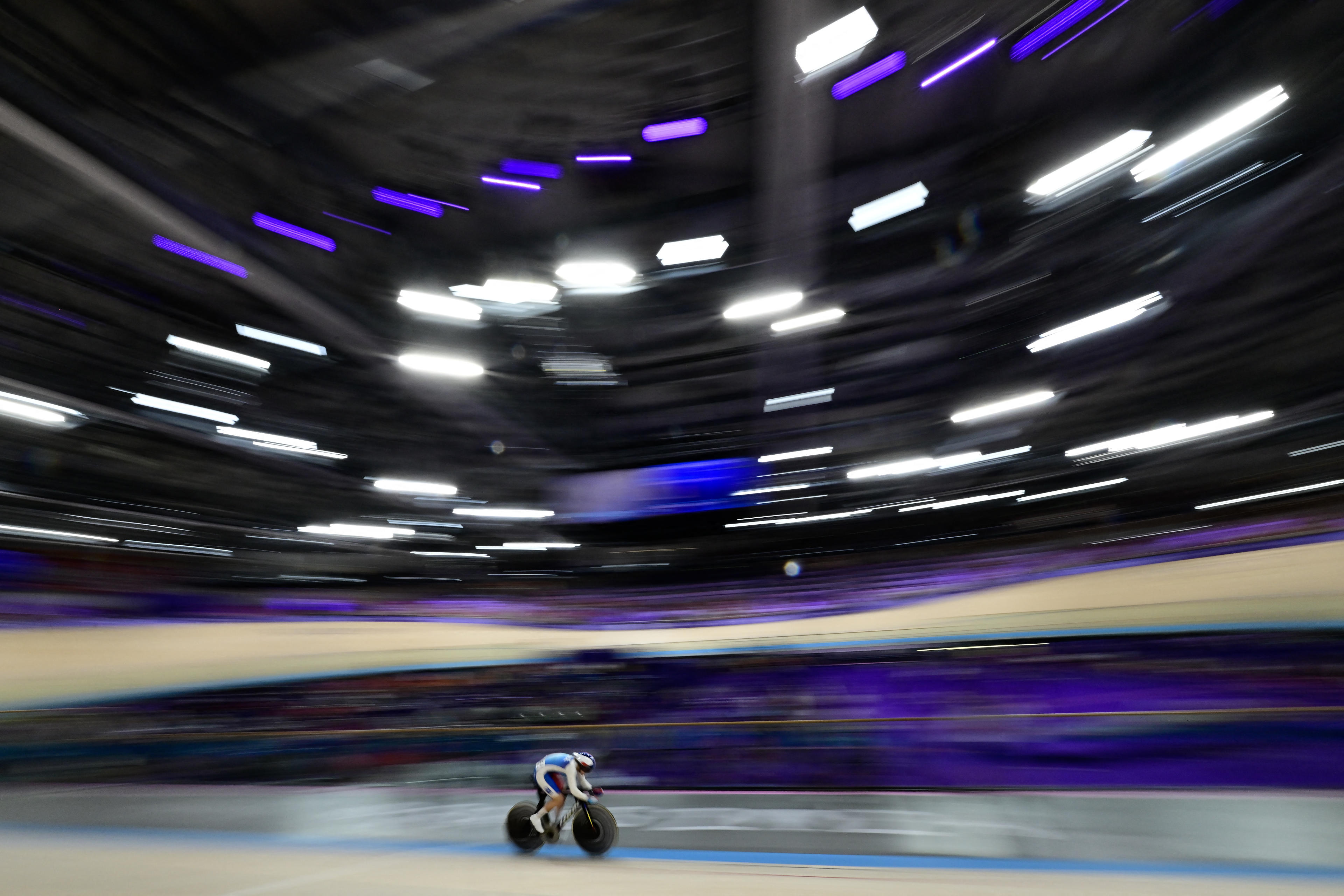 Mathilde Gros of France competes in a women's track cycling sprint qualifying round for the Paris 2024 Olympic Games at the Saint-Quentin-en-Yvelines National Velodrome in Montigny-le-Bretonneux, southwest of Paris, on August 9, 2024. (John MacDougall/AFP/Getty Images)