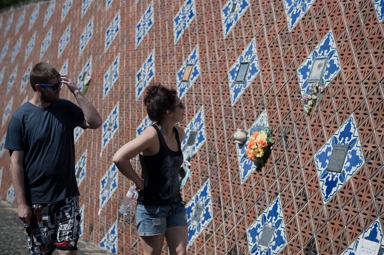 This picture taken on December 4, 2014 shows people visiting the Ban Nam Khem tsunami memorial park wall in Khao Lak