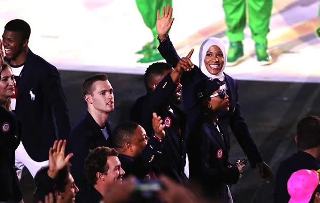 She walks with the US team during the Olympics Opening Ceremony.