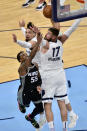 Sacramento Kings guard Delon Wright (55) shoots against Memphis Grizzlies center Jonas Valanciunas (17) and forward Dillon Brooks in the second half of an NBA basketball game Thursday, May 13, 2021, in Memphis, Tenn. (AP Photo/Brandon Dill)