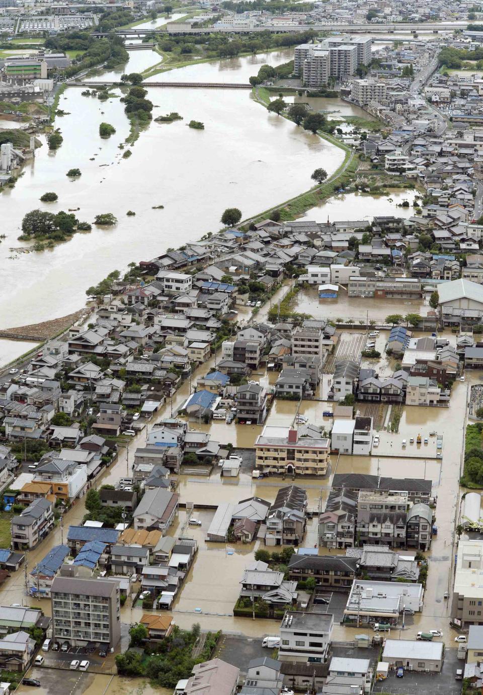 An aerial view shows residential areas flooded by the Katsura river after tropical storm Man-yi, also known locally as Typhoon No.18, hit Kyoto, western Japan, in this photo taken by Kyodo September 16, 2013. Torrential rain hit western Japan on Monday morning as the Man-yi made landfall in the country's central region, prompting the weather agency to warn of "unprecedented heavy rain" and urge people to take safety precautions. In Kyoto Prefecture, some 260,000 residents were ordered to evacuate, including about 81,000 in Fukuchiyama, Kyodo news reported. Mandatory Credit. REUTERS/Kyodo