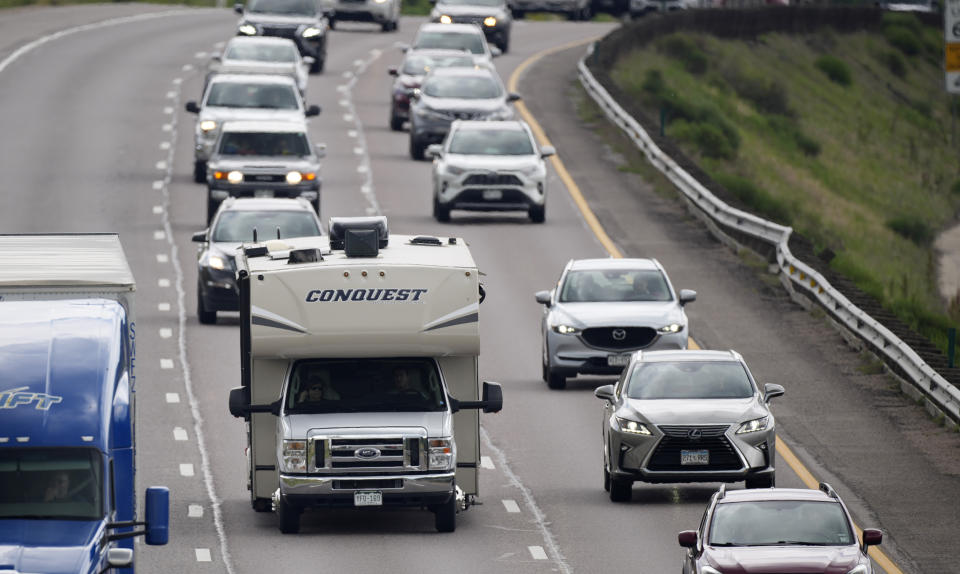 FILE - In this July 1, 2021, file photo, motorists head west along Interstate 70 to get an early start on the Fourth of July holiday weekend near Golden, Colo. Americans enjoying newfound liberty are expected to travel and gather for cookouts, fireworks and family reunions over the Fourth of July weekend in numbers not seen since pre-pandemic days. (AP Photo/David Zalubowski, File)