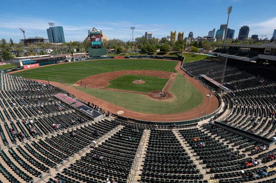 Baseball fans sit watch an exhibition game between the San Francisco Giants and Oakland A’s at Sutter Health Park in West Sacramento in 2021. On Tuesday, the Sacramento Kings, owners of the River Cats and Sutter Health Park, announced the Oakland A’s will play three seasons in West Sacramento before moving to Oakland. Paul Kitagaki Jr./Sacramento Bee file