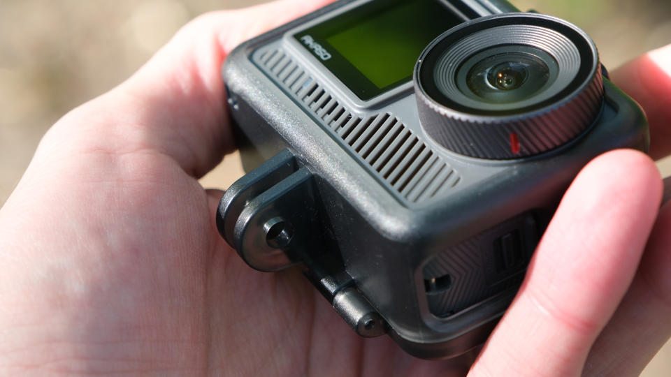 Akaso Brave 8 Lite action camera held in a hand outside