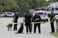 <p>Law enforcement officers, including a K-9 unit, investigate near the scene of a shooting where there were multiple fatalities in an industrial area near Orlando, Fla., Monday, June 5, 2017. The Orange County Sheriff’s Office said on its official Twitter account that the situation has been contained. (AP Photo/John Raoux) </p>