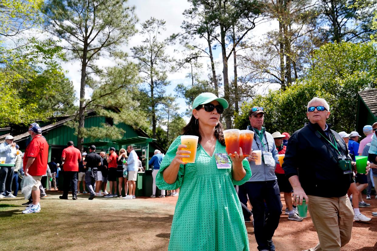 FILE - Apr 8, 2022; Augusta, Georgia, USA; Patrons carry beverages at the concession stand near the No. 7 leaderboard during the second round of The Masters golf tournament at Augusta National Golf Course. Mandatory Credit: Danielle Parhizkaran-Augusta Chronicle/USA TODAY Sports