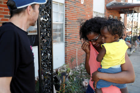 Shauntese Russell, 23, cries while talking with one of her neighbors in the aftermath of Hurricane Michael in Lynn Haven, Florida, U.S., October 14, 2018. REUTERS/Terray Sylvester