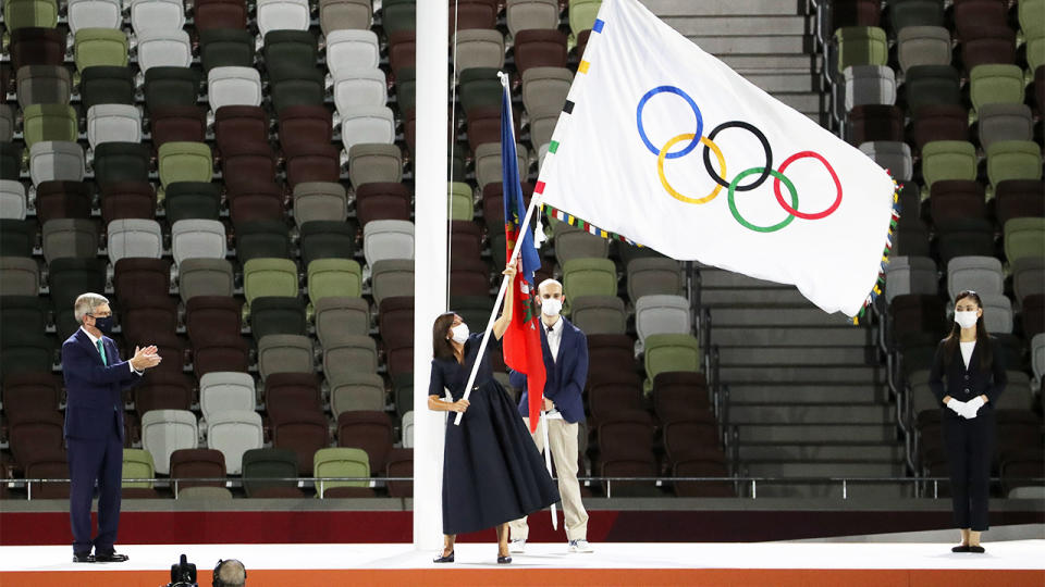 Mayor of Paris Anne Hidalgo waves the Olympics flag at the Tokyo Olympics closing ceremony.