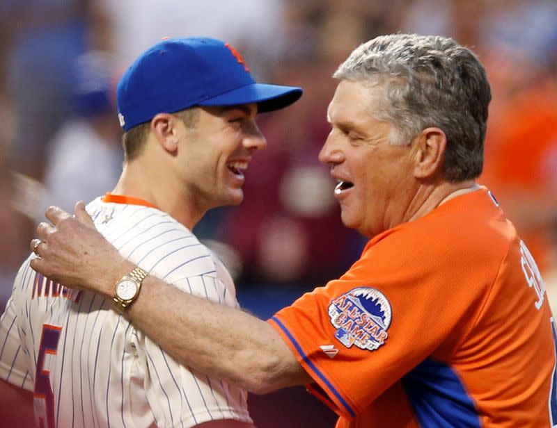 FILE PHOTO: Former New York Mets pitcher Tom Seaver is greeted by the Mets' David Wright after throwing out the ceremonial first pitch ahead of Major League Baseball's All-Star Game in New York