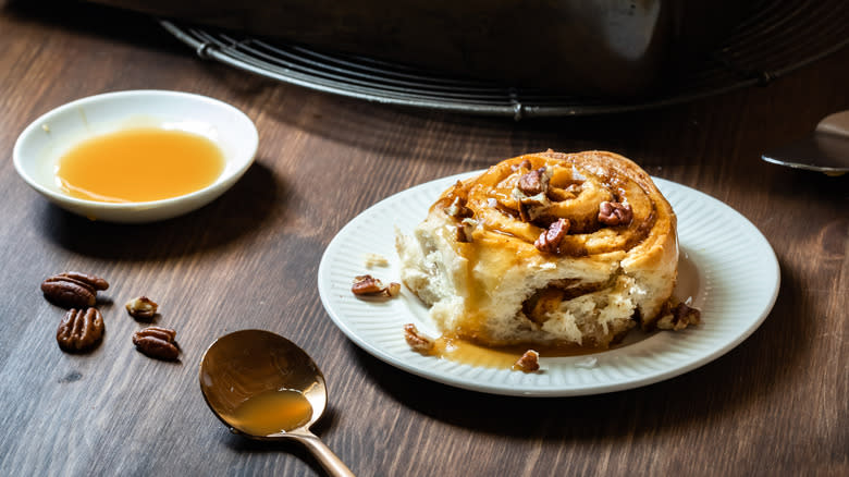 sticky bun on plate with nuts