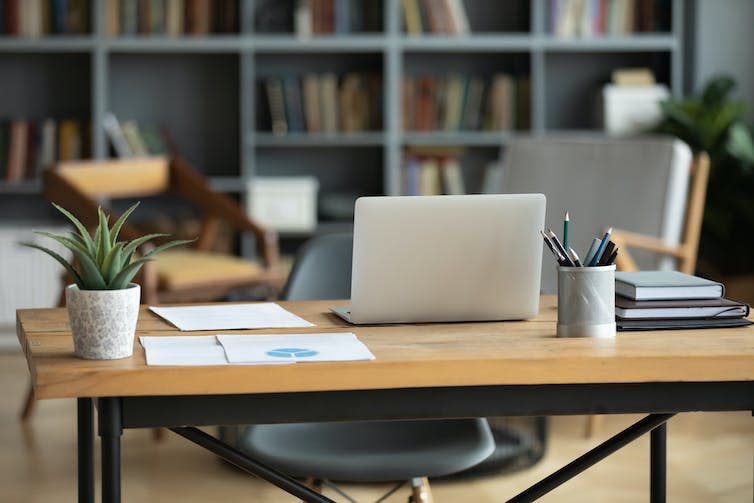 A wooden desk in an office.