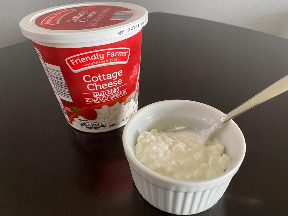 Friendly Farms cottage cheese in a bowl with container behind it