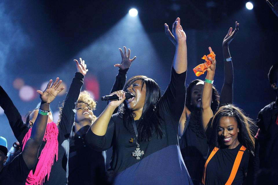 Mandisa, center, sings "Overcomer" for the crowd during the 45th annual Dove Awards at Lipscomb University's Allen Arena Oct. 7, 2014.