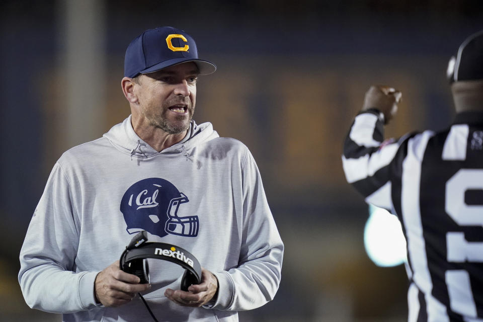 California head coach Justin Wilcox talks to side judge Gary Reed during the second half of an NCAA college football against Washington game in Berkeley, Calif., Saturday, Oct. 22, 2022. (AP Photo/Godofredo A. Vásquez)