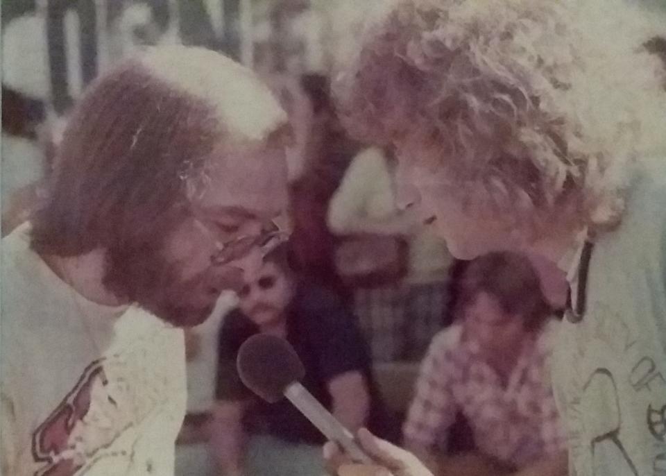 Bill Compton and Lee Powell at a peach-eating contest in 1972 at a Phoenix record store, a promotional event for the Allman Brothers' "Eat a Peach."