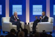 Former U.S. President Bill Clinton (L) listens to U.S. President Barack Obama speak about healthcare at the Clinton Global Initiative (CGI) in New York September 24, 2013. The CGI was created by Clinton in 2005 to gather global leaders to discuss solutions to the world's problems. REUTERS/Lucas Jackson (UNITED STATES - Tags: POLITICS HEALTH)