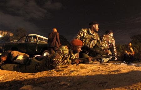 Kenyan police take cover near the scene of an explosion outside the Pangani police station in the capital Nairobi April 23, 2014. REUTERS/Thomas Mukoya