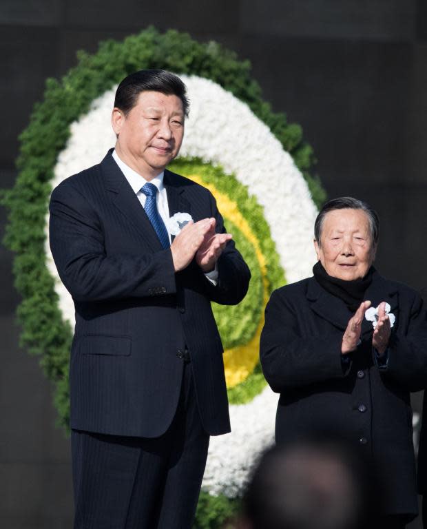 Chinese President Xi Jinping (L) and Xia Shuqin, a survivor of the Nanjing Massacre, attends a memorial ceremony on China's first National Memorial Day for Nanjing Massacre Victims in Nanjing on December 13, 2014