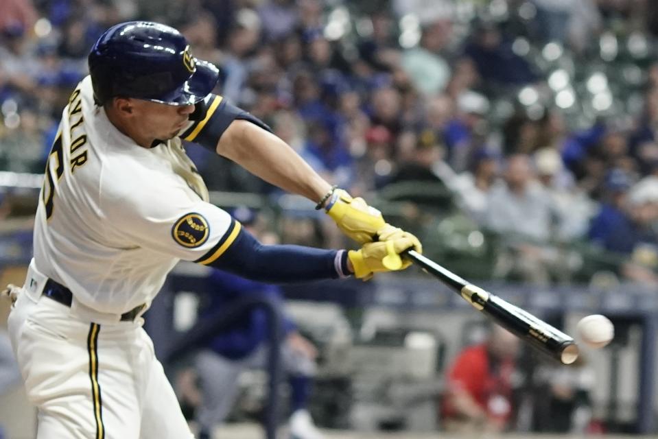 Milwaukee Brewers' Tyrone Taylor hits a single during the third inning of a baseball game against the Los Angeles Dodgers Tuesday, May 9, 2023, in Milwaukee. (AP Photo/Morry Gash)