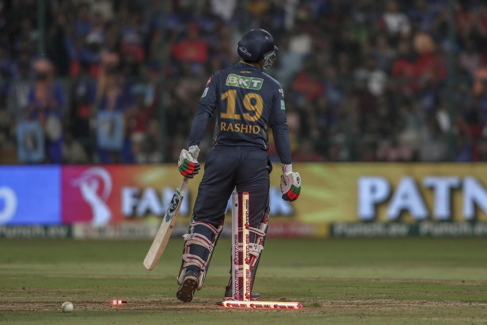 Gujarat Titans' Rashid Khan is bowled out during the Indian Premier League cricket match between Royal Challengers Bengaluru and Gujarat Titans in Bengaluru, India, Saturday, May 4, 2024. (AP Photo)