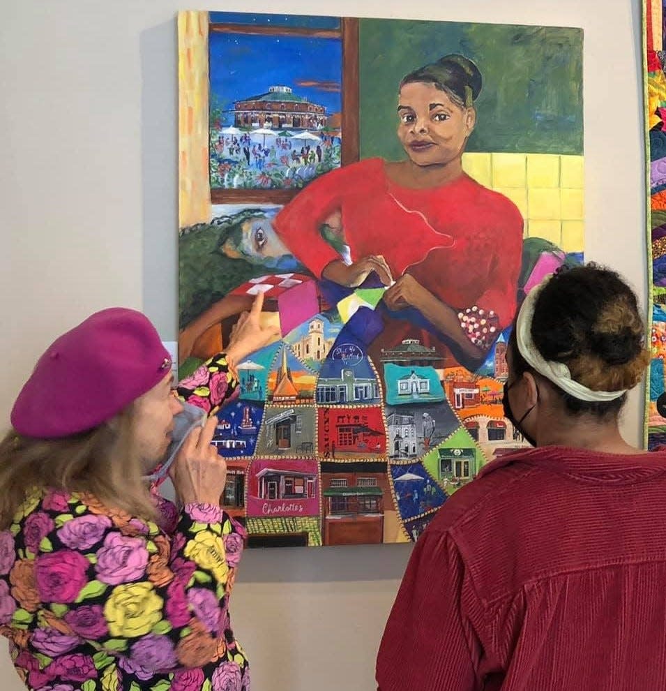 On the left, Artist Catherine Venable describes her 'The Page Turner' painting on exhibit at the Petersburg Area Art League in April of 2021.