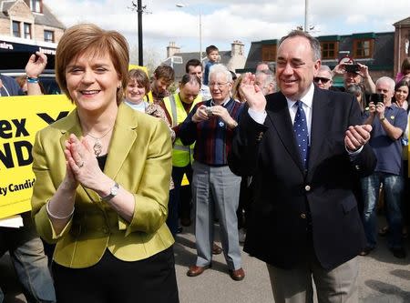 The leader of the Scottish National Party (SNP) Nicola Sturgeon is applauded by former leader and local candidate Alex Salmond during campaigning in Inverurie, Aberdeenshire, April 18, 2015. REUTERS/Russell Cheyne