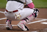 St. Louis Cardinals catcher Yadier Molina wears pink and a Mother's Day message on his shoe as he works behind the plate during the first inning of a baseball game against the Colorado Rockies Sunday, May 9, 2021, in St. Louis. (AP Photo/Jeff Roberson)