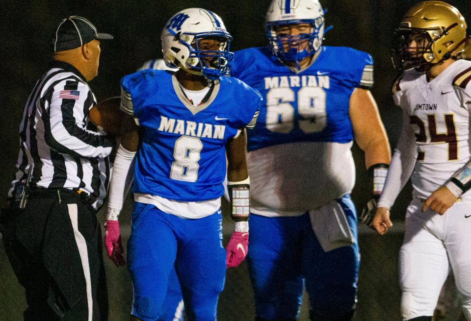 Marian's Kapafule Lusanga celebrates scoring during the Marian vs. Jimtown sectional championship football game Friday, Nov. 5, 2021 at Marian High School in Mishawaka. 