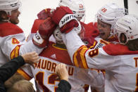 Calgary Flames' Johnny Gaudreau (13) celebrates with teammates after scoring during the first period of an NHL hockey game against the Pittsburgh Penguins in Pittsburgh, Thursday, Oct. 28, 2021. (AP Photo/Gene J. Puskar)