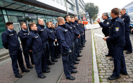 Police officers get their instructions as 60,000 people in Germany's financial capital are about to evacuate the city while experts defuse an unexploded British World War Two bomb found during renovations on the university's campus in Frankfurt, Germany, September 3, 2017. REUTERS/Kai Pfaffenbach