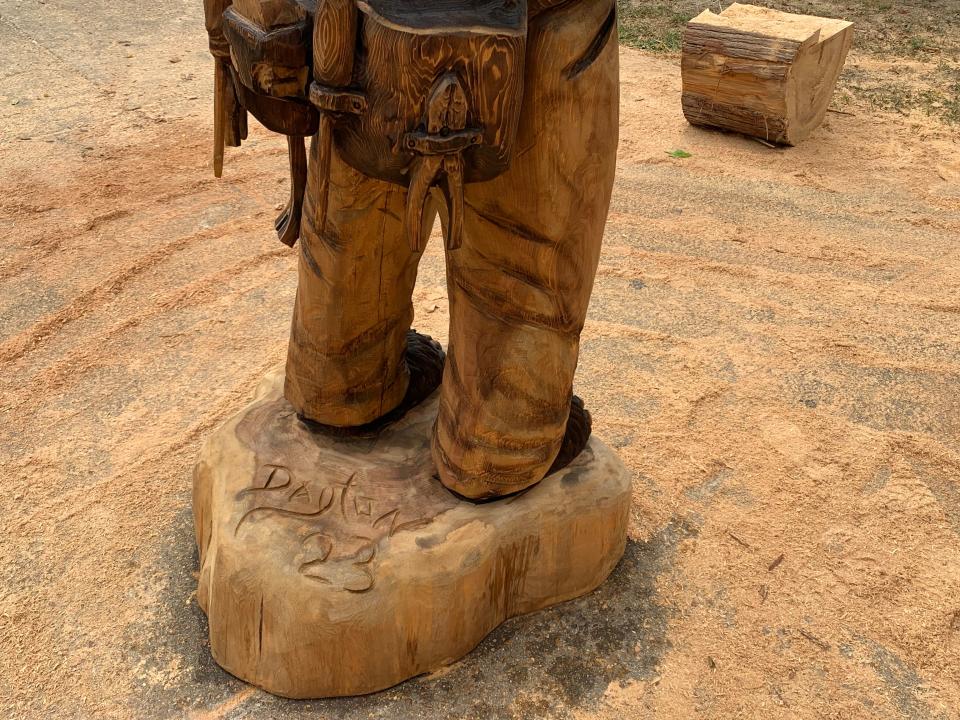 Dayton Scoggin's signature on the bear statue he carved for the 2023 Great Delta Bear Affair in Rolling Fork.