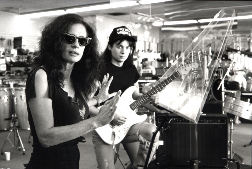 Director Penelope Spheeris goes over a scene with star Mike Myers on the set of "Wayne's World."