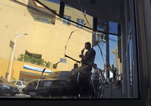 Brazilian militarized policemen check the Nova Brasilia Peace Police Unit (UPP), which was attacked by alleged drug traffickers, at the Alemao shantytown complex, in Rio de Janeiro. Crack military police officers have tightened security at a Rio favela following a shootout with suspected drug traffickers that left a policewoman dead, authorities said Wednesday