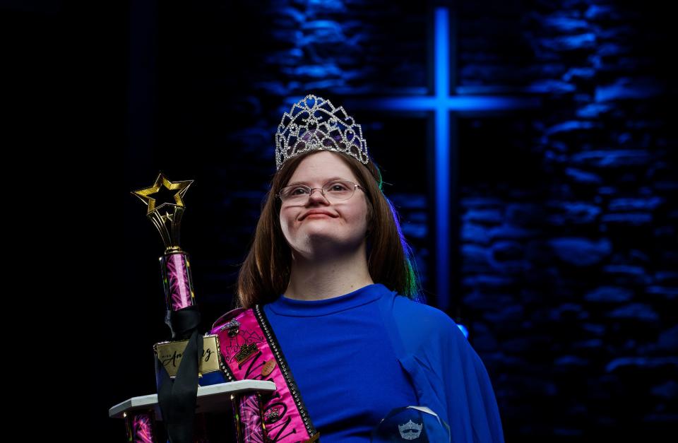 Mickey Deputy stands tall as she wears a tiara and sash and holds some of her many pageant awards Wednesday, Feb. 22, 2023, inside Victory Christian Church in Franklin, Indiana, a place of great importance to her. As millions of Americans gathered around their TVs on Super Bowl Sunday, Deputy was competing in her final local Miss America Organization pageant -- a pursuit to which she's dedicated nearly seven years of her life.