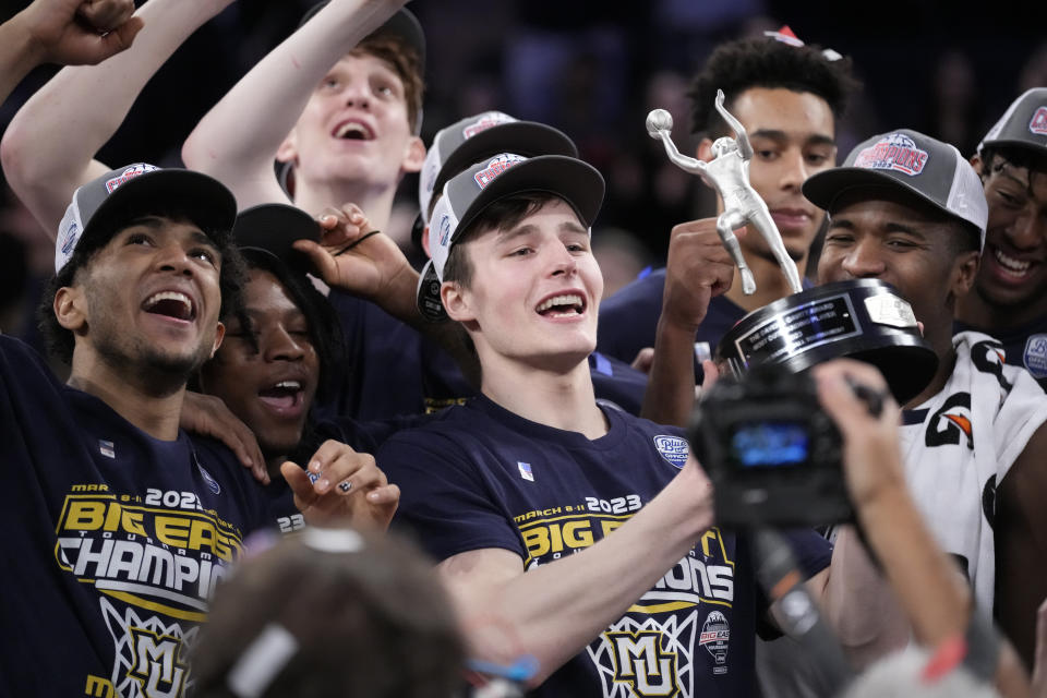Marquette's Tyler Kolek, center, holds the tournament most outstanding player trophy after winning an NCAA college basketball game against Xavier for the championship of the Big East men's tournament, Saturday, March 11, 2023, in New York. (AP Photo/John Minchillo)