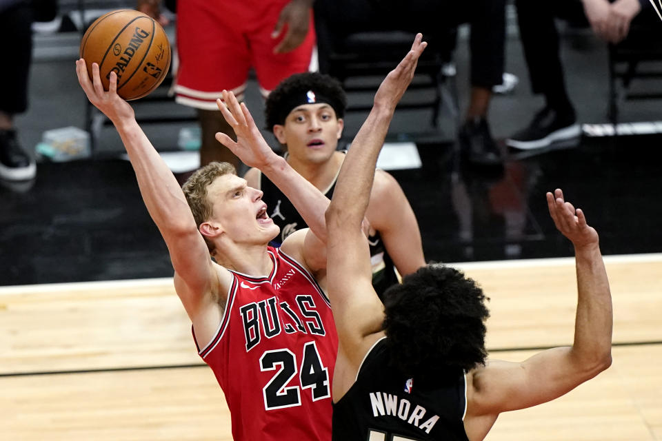 FILE - Chicago Bulls forward Lauri Markkanen, left, shoots against Milwaukee Bucks forward Jordan Nwora during the second half of an NBA basketball game in Chicago, in this Sunday, May 16, 2021, file photo. The Cavaliers have agreed to acquire restricted free agent forward Lauri Markkanen from Chicago in a three-way trade that will send forward Larry Nance Jr. from Cleveland to Portland, a person familiar with the deal told the Associated Press on Friday, Aug. 27, 2021. (AP Photo/Nam Y. Huh, File)